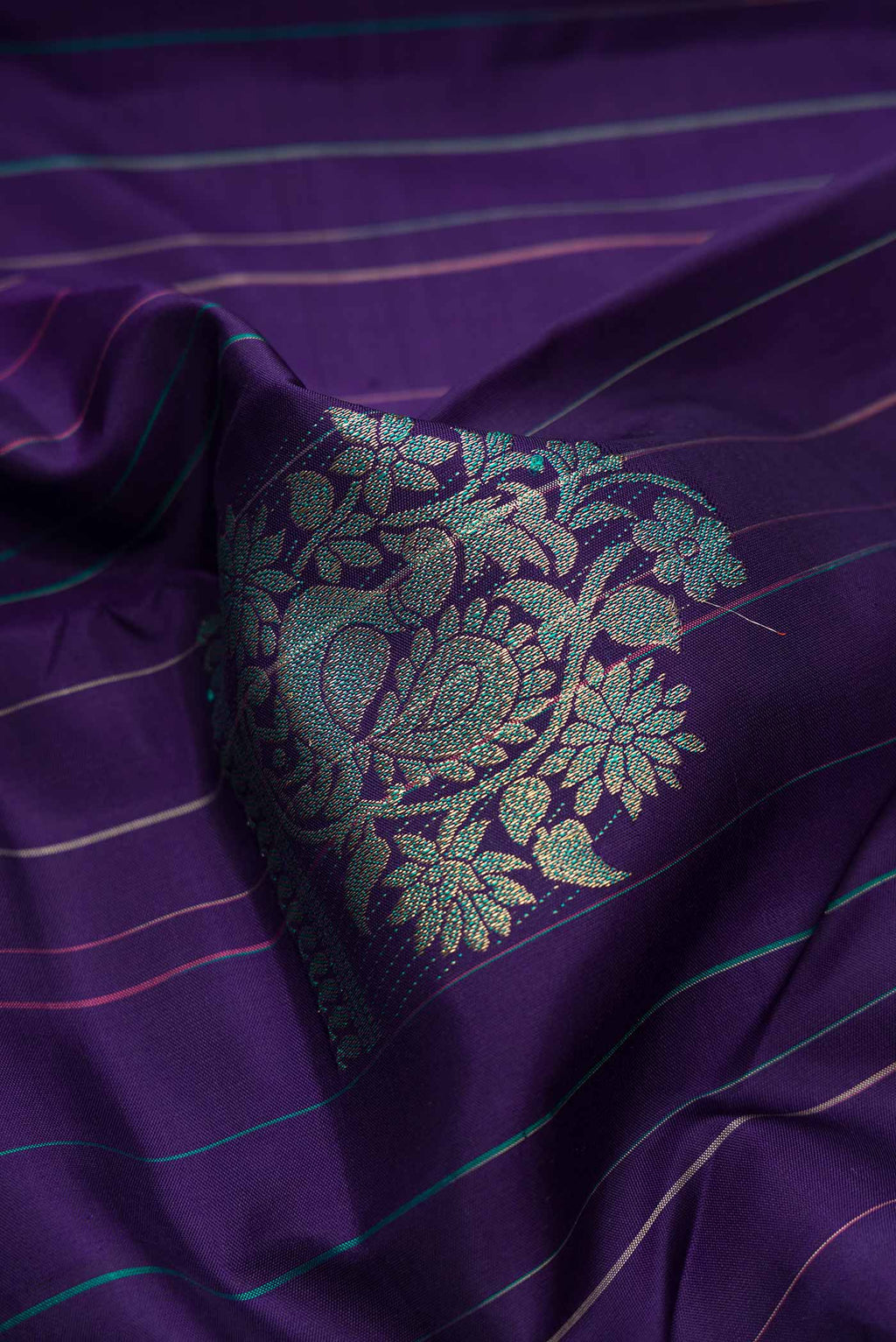 Close up of Pure Silk Pure Zari Navy Blue Dual Tone Kanchipuram Saree with Stripes on the body and Without Border displaying folds