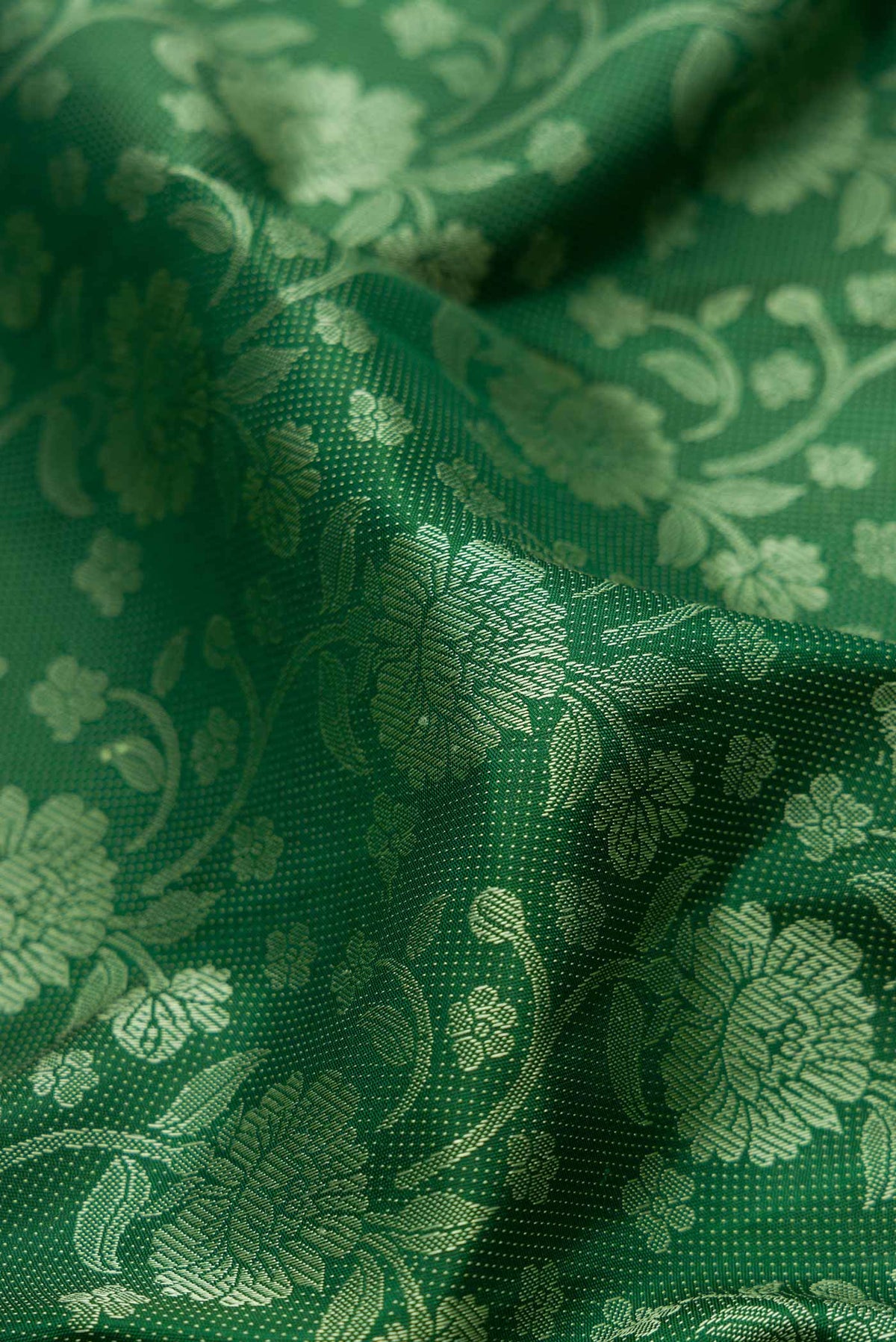 Close up of Pure Silk Pure Zari Green Dual Tone Kanchipuram Saree with Jacquard design on the body and Fancy Border displaying folds
