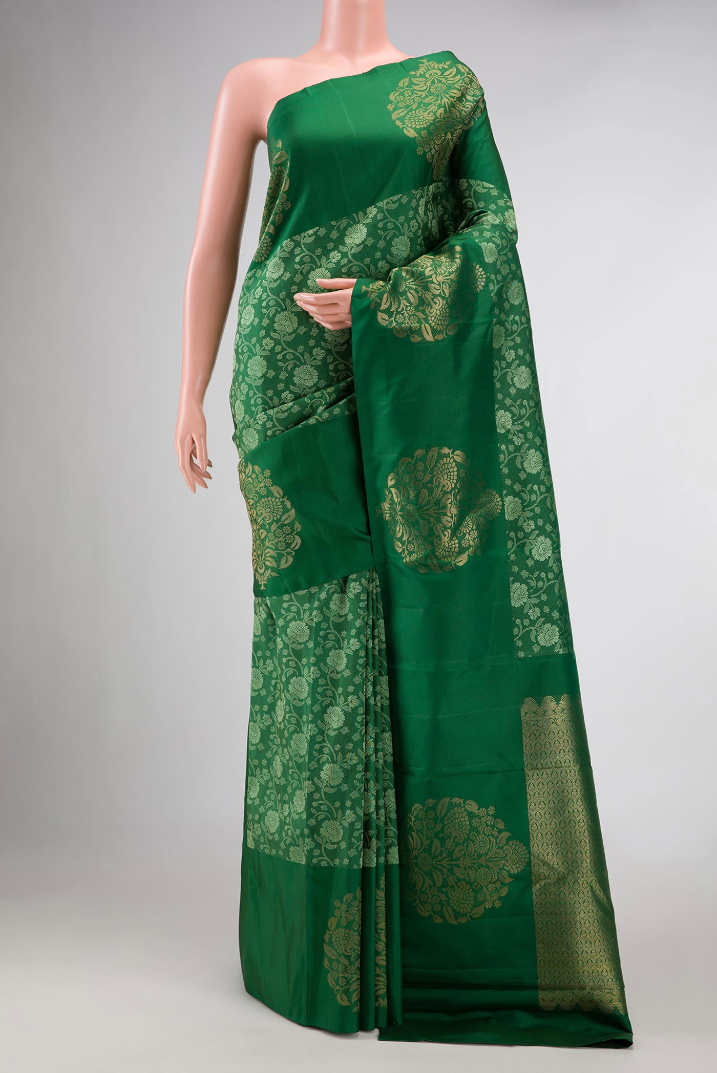 Pure Silk Pure Zari Green Dual Tone Kanchipuram Saree with Jacquard design on the body and Fancy Border displayed on a mannequin