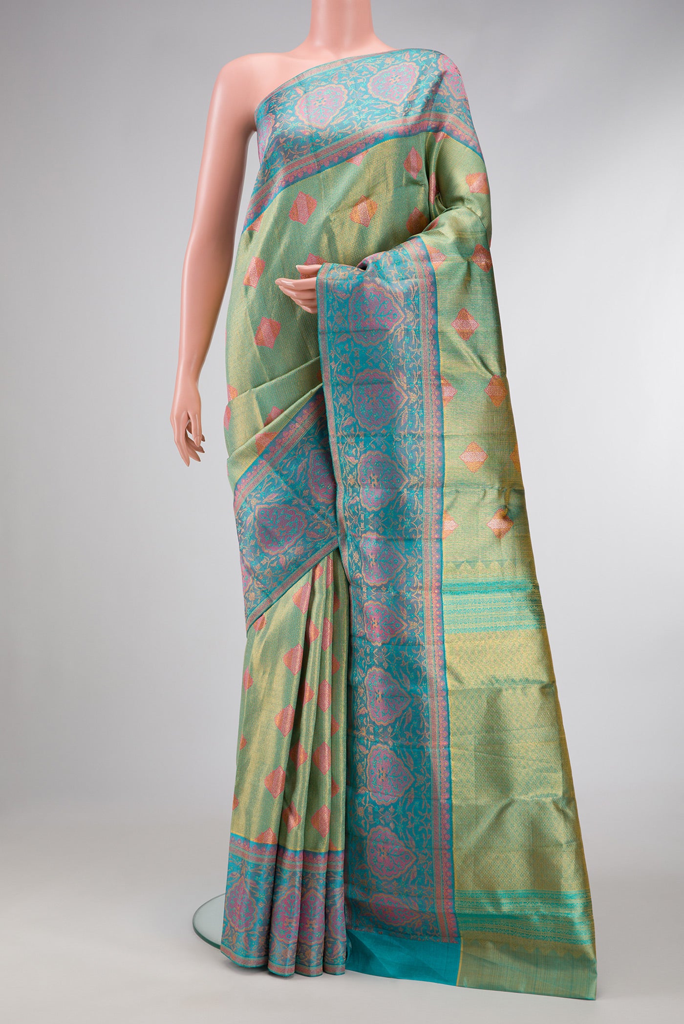 Green Dual Tone Kanjivaram Tissue Silk Saree with Zari Brocade on the body and Fancy Border.  displayed on a mannequin