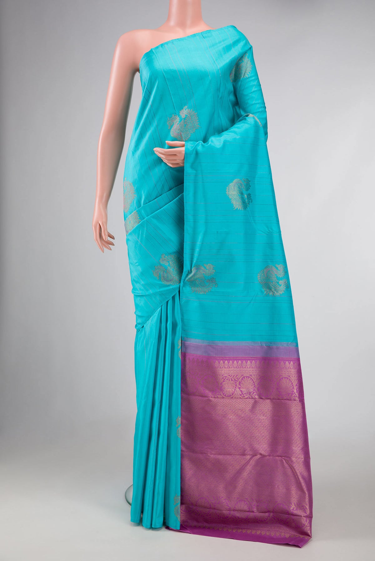 Sky Blue Dual Tone Kanchipuram Silk Saree with Zari Butta on the body and Without Border displayed on a mannequin