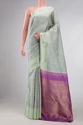 Pista Green Dual Tone Kanchipuram Silk Saree with Jacquard design on the body and Fancy Border displayed on a mannequin
