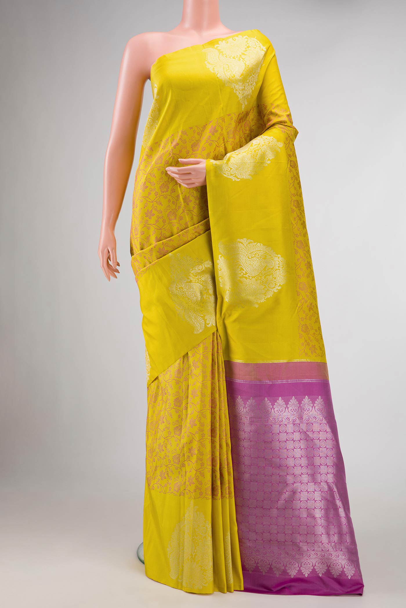 Pure Silk Pure Zari Mustard Dual Tone Kanchipuram Saree with Jacquard design on the body and Fancy Border displayed on a mannequin