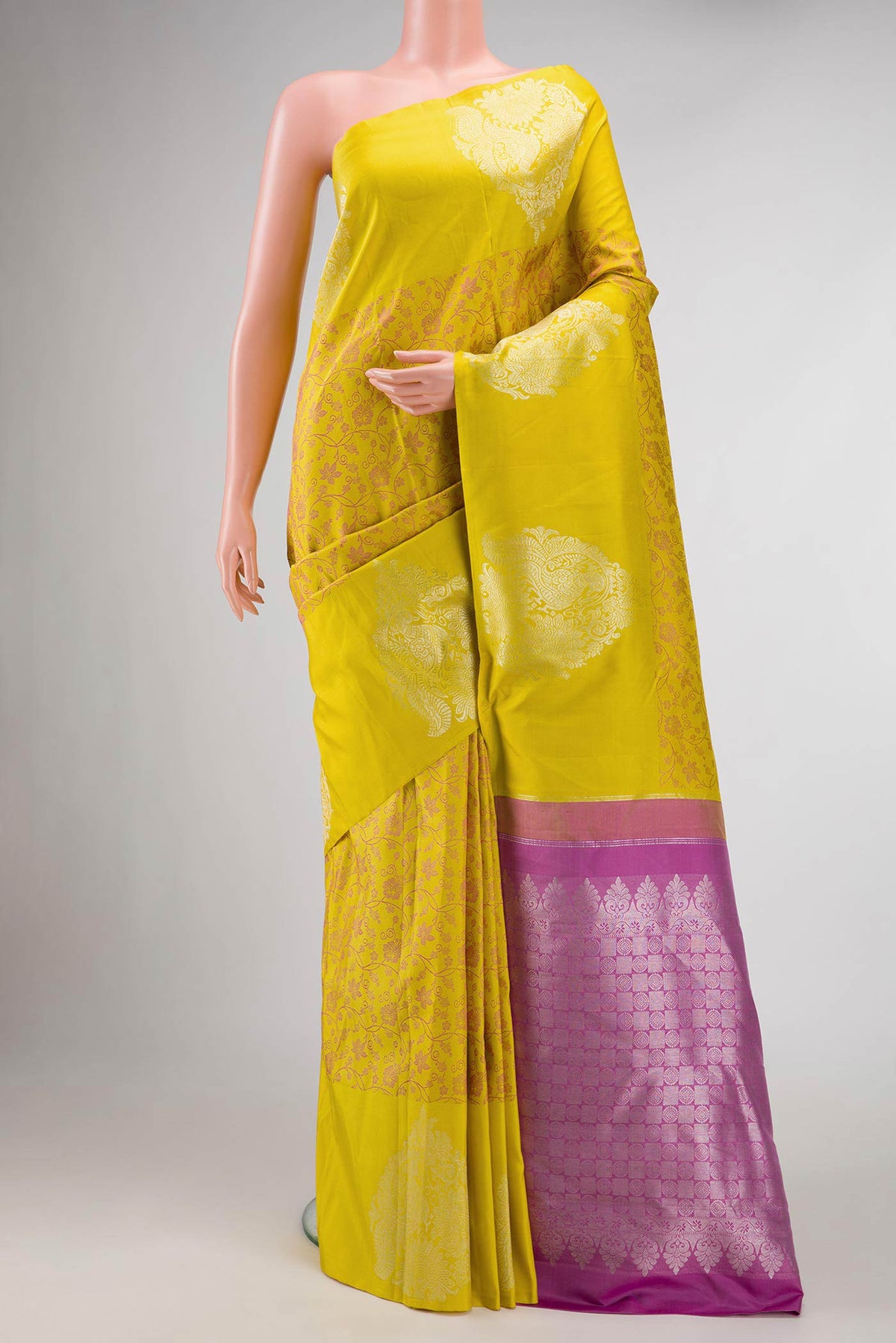 Pure Silk Pure Zari Mustard Dual Tone Kanchipuram Saree with Jacquard design on the body and Fancy Border displayed on a mannequin