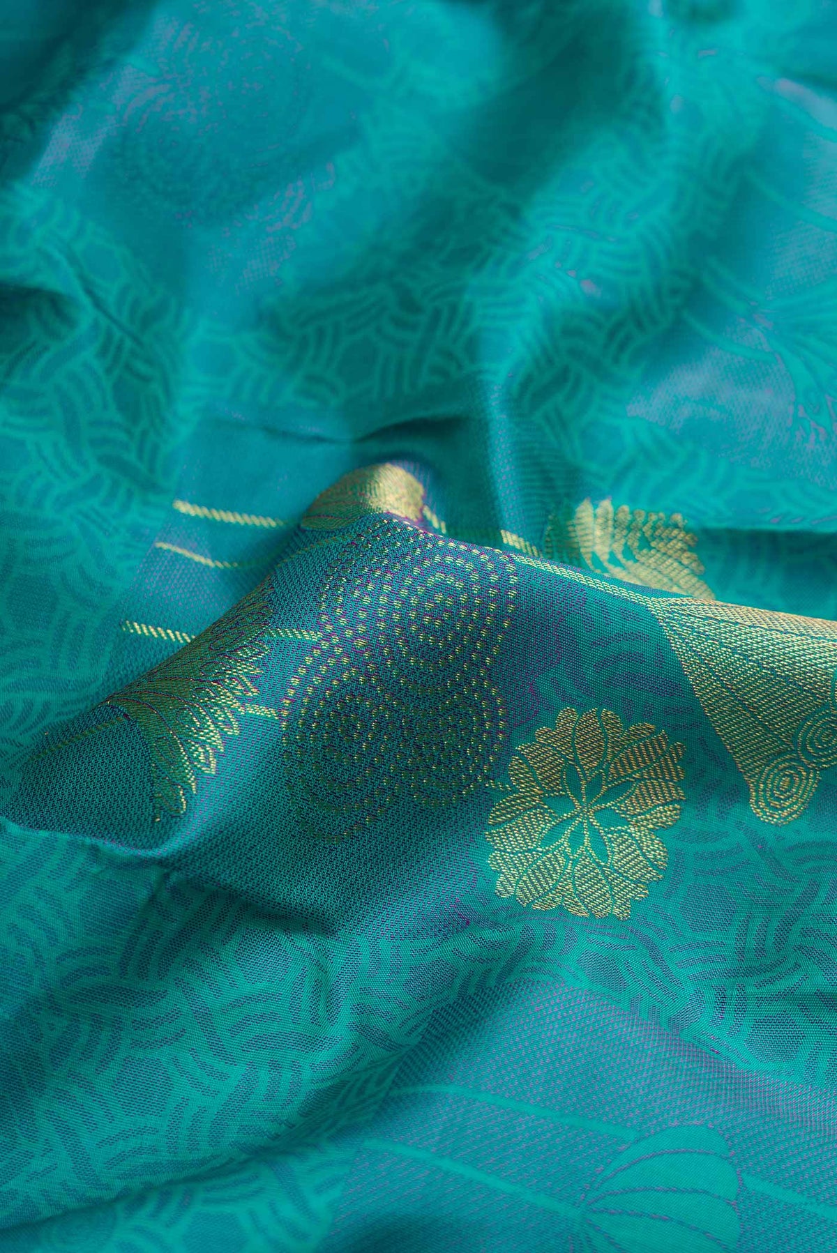 Close up of Sea Green Dual Tone Kanchipuram Silk Saree with Jacquard With Zari Butta on the body and Without Border displaying folds