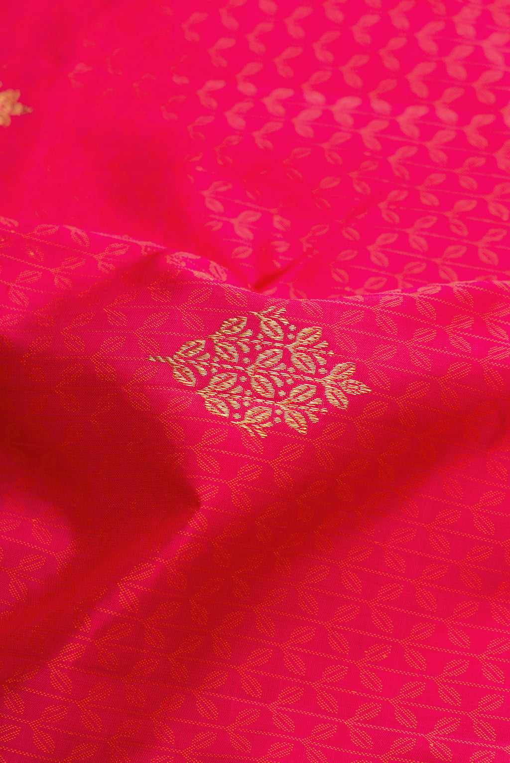 Close up of Pure Silk Pure Zari Pink Dual Tone Kanchipuram Saree with Jacquard With Zari Butta on the body and Zari Border.  displaying folds