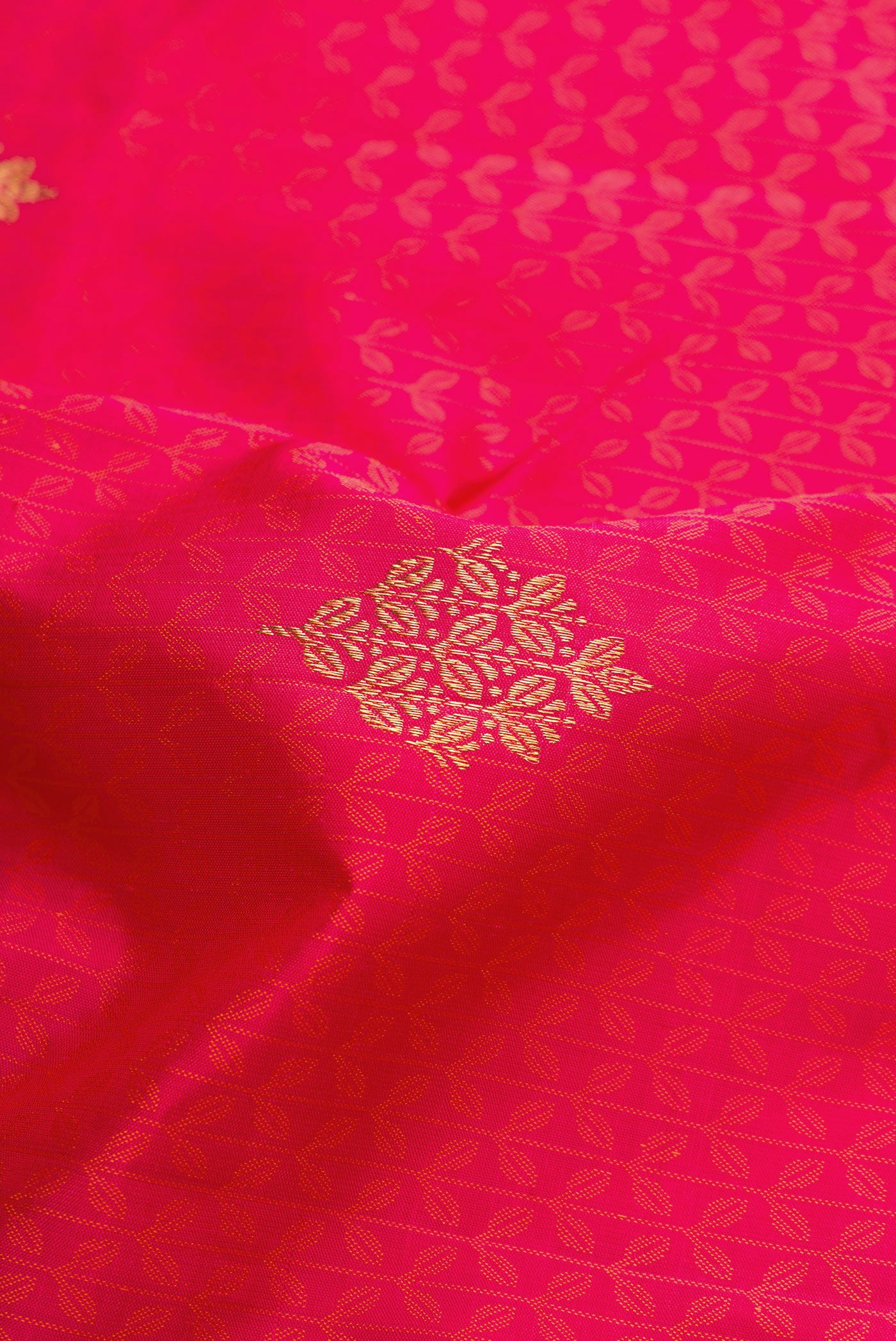 Close up of Pure Silk Pure Zari Pink Dual Tone Kanchipuram Saree with Jacquard With Zari Butta on the body and Zari Border.  displaying folds