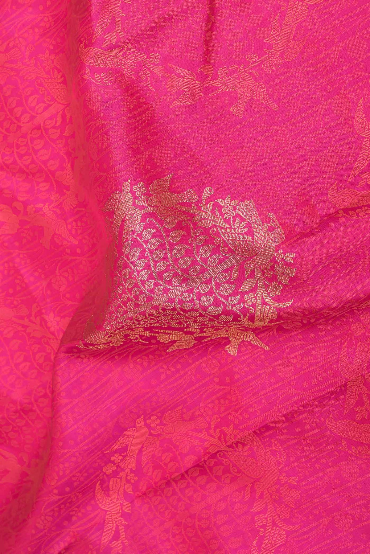 Close up of Pink Dual Tone Kanchipuram Saree with Jacquard With Thread Butta on the body and Zari Border displaying folds