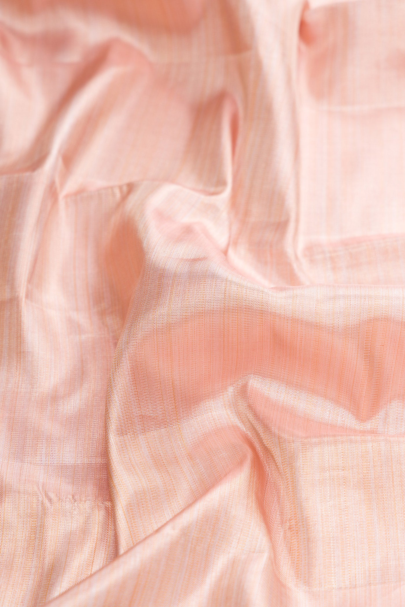 Close up of Rose Gold Dual Tone Kanjivaram Tissue Silk Saree with Plain Body and Temple Border.  displaying folds