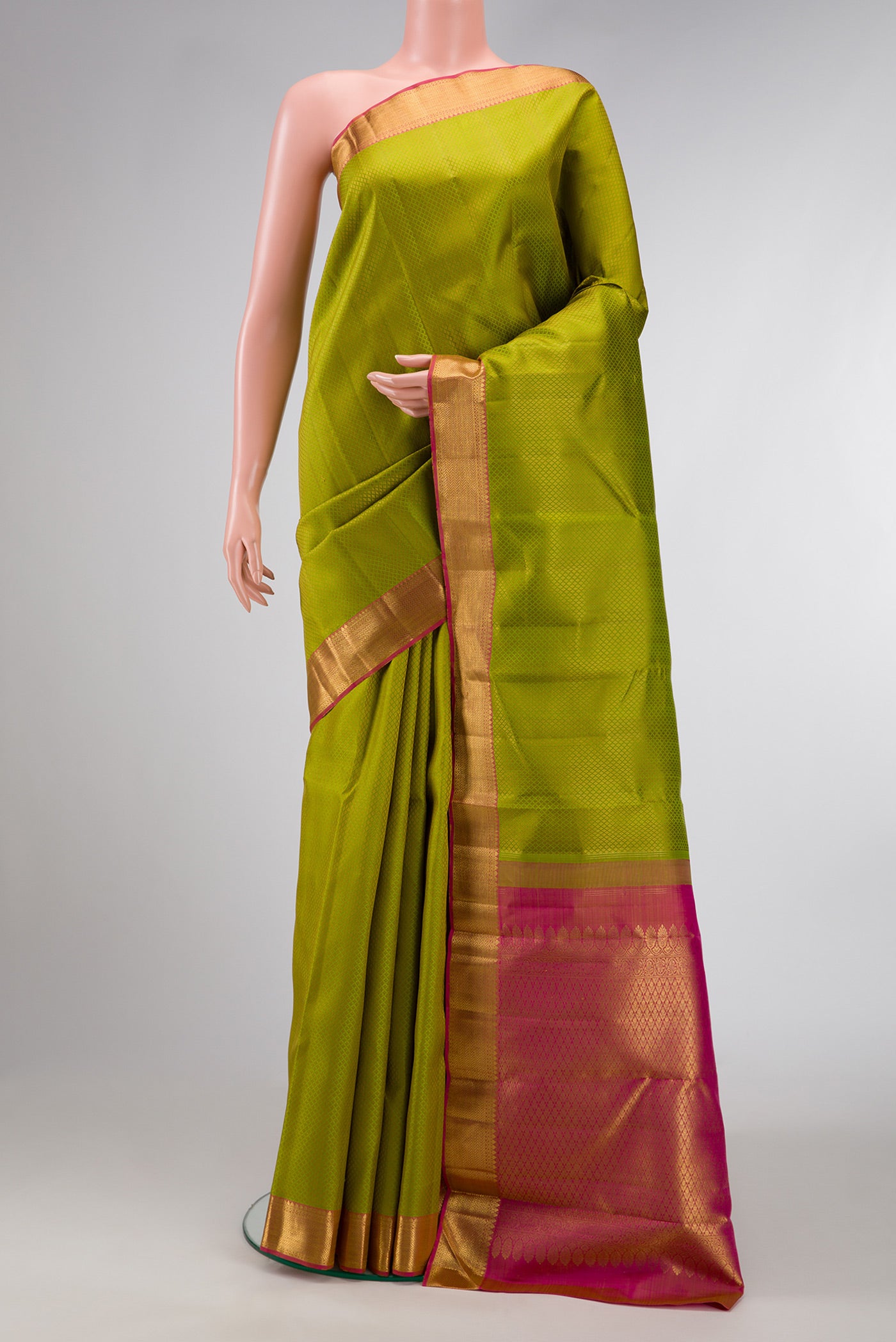 Pista Green Dual Tone Kanjivaram Silk Saree with Jacquard design on the body and Zari Border.  displayed on a mannequin
