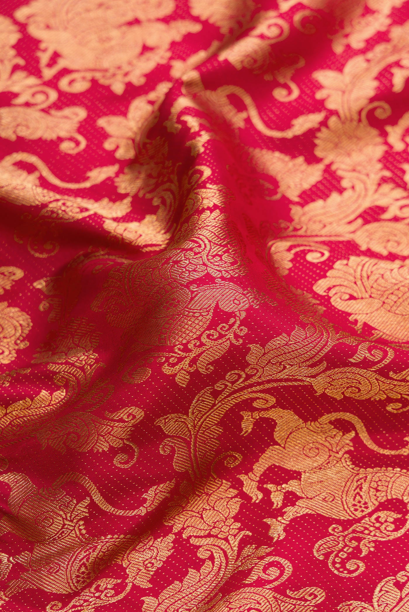 Close up of Maroon Dual Tone Kanchipuram Silk Saree with Zari Brocade on the body and Zari Border.  displaying folds