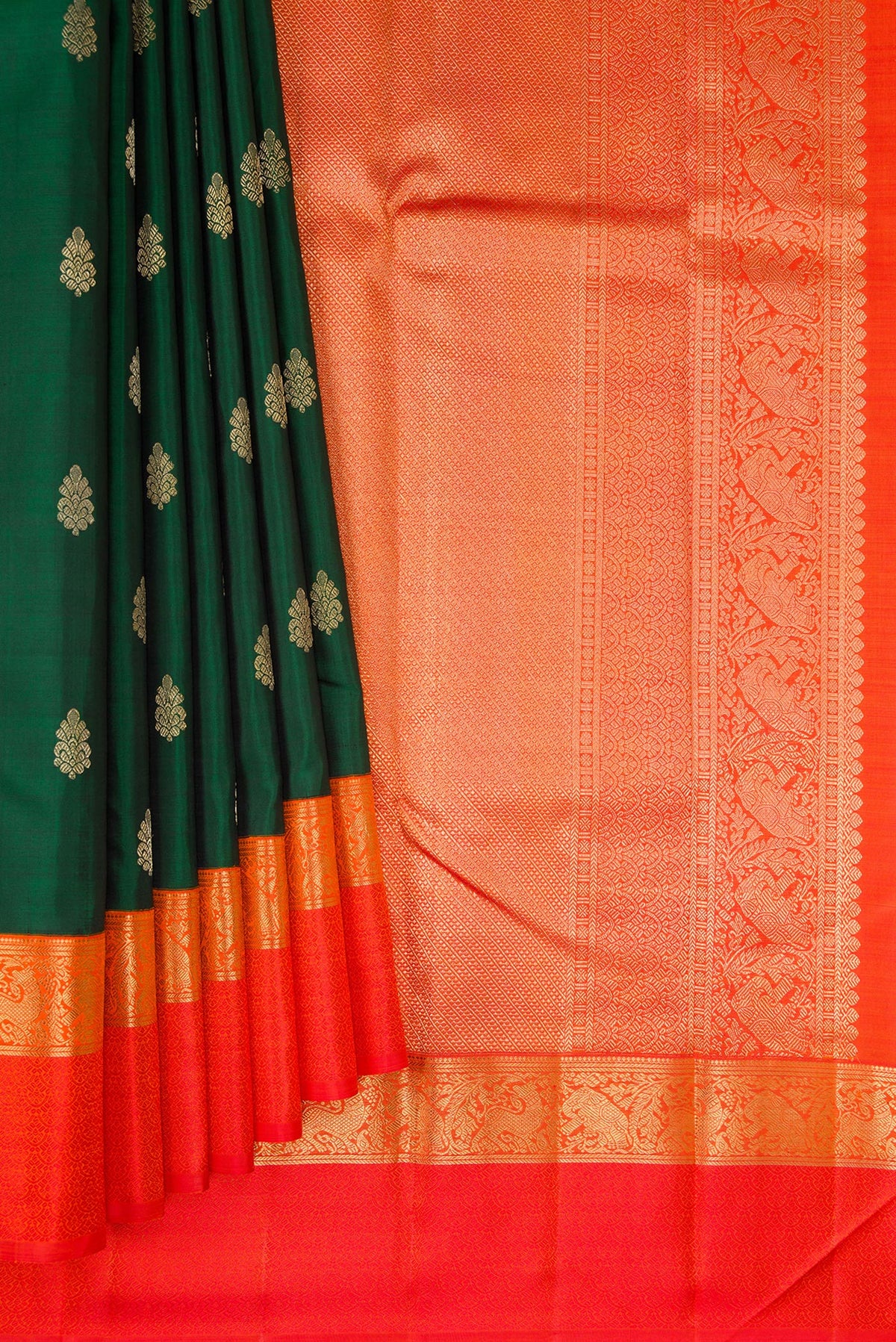 Pleats and pallu of Pure Silk Pure Zari Bottle Green Dual Tone Kanchipuram Saree with Zari Butta on the body and Zari And Thread Border. 