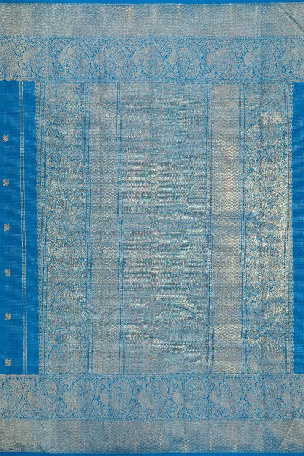 Close up image of the pallu of Pure Silk Pure Zari Peacock Blue Kanjivaram Saree with Zari Butta on the body and Zari Border. 