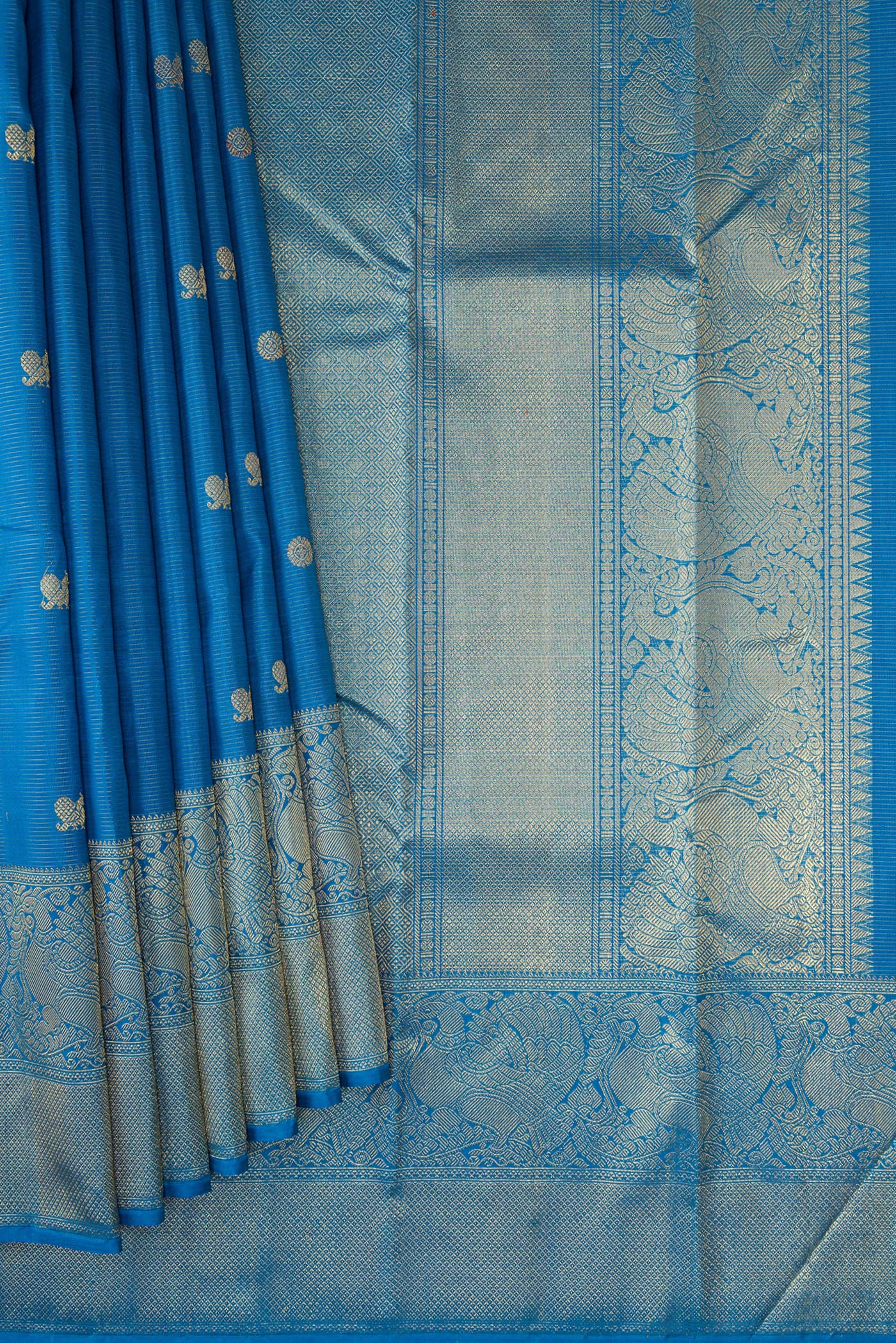 Pleats and pallu of Pure Silk Pure Zari Peacock Blue Kanjivaram Saree with Zari Butta on the body and Zari Border. 