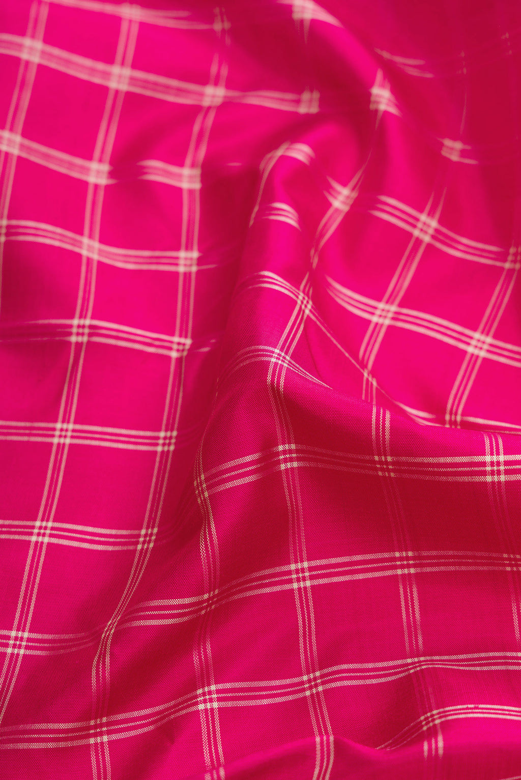 Close up of Pink Dual Tone Kanjivaram Silk Saree with Checked design on the body and Zari Border.  displaying folds