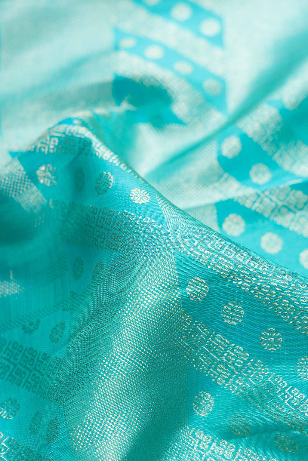 Close up of Sky Blue Dual Tone Kanchipuram Silk Saree with Zari Brocade on the body and Zari Border.  displaying folds