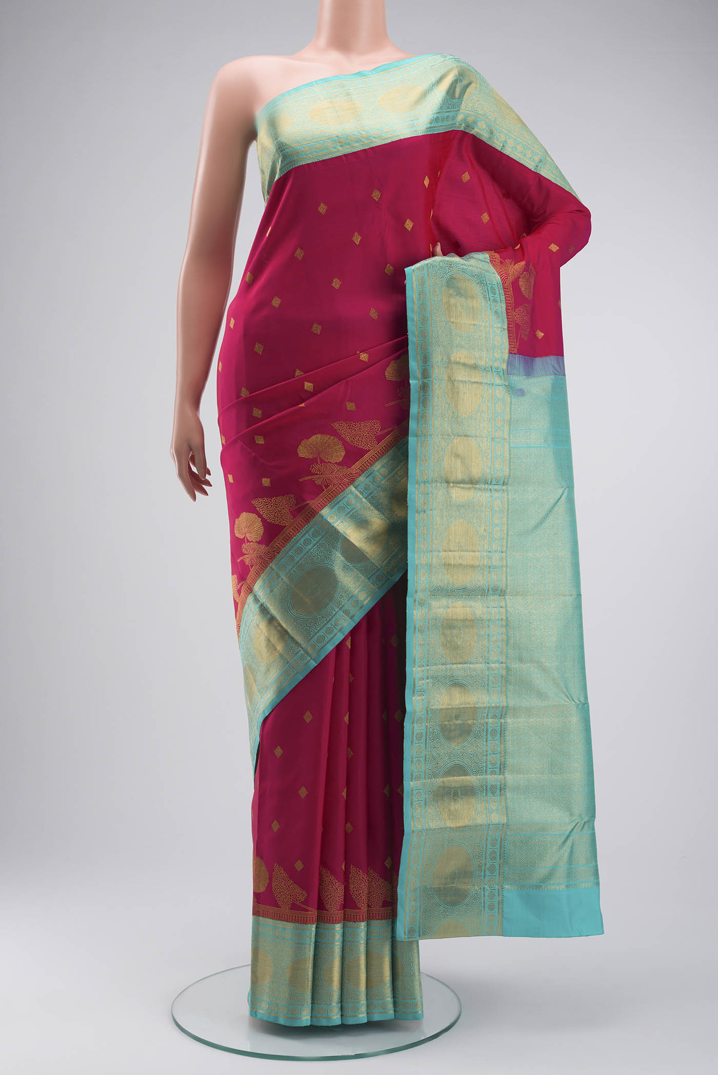Pink Kanchipuram Silk Saree with Zari Butta on the body and Zari Border displayed on a mannequin