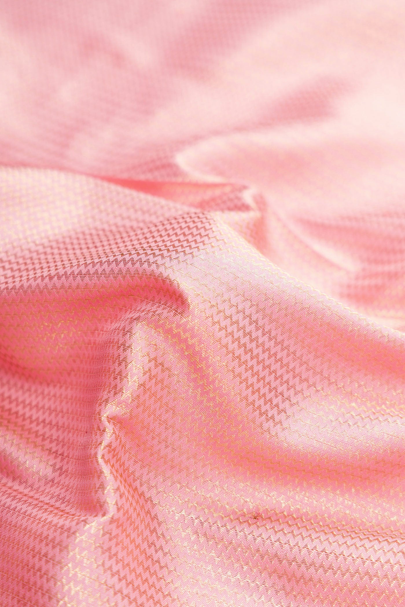 Close up of Pink Dual Tone Kanchipuram Silk Saree with Zari Brocade on the body and Zari Border.  displaying folds