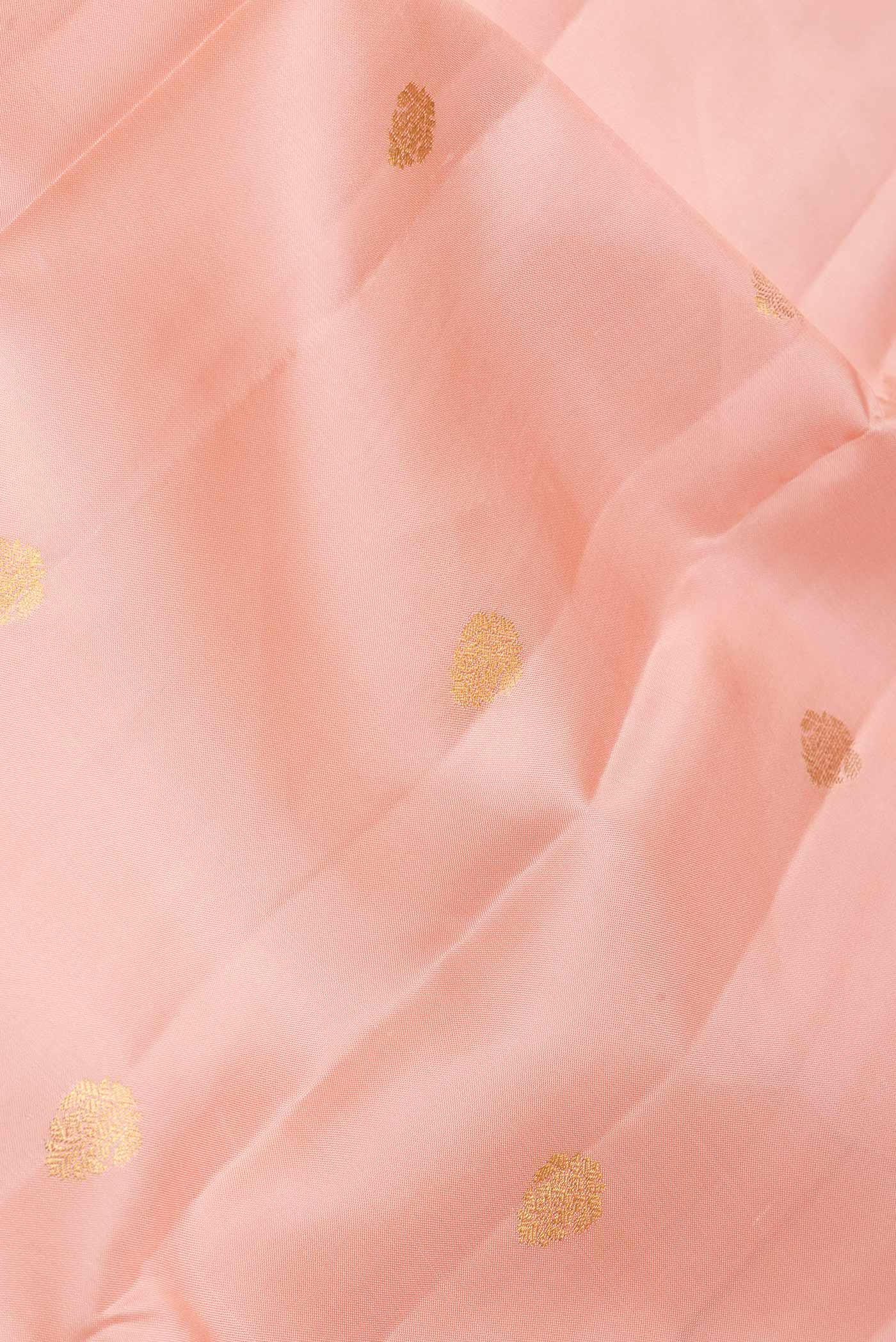 Close up of Golden Peach Dual Tone Kanjivaram Saree with Zari Butta on the body and Zari Border.  displaying folds