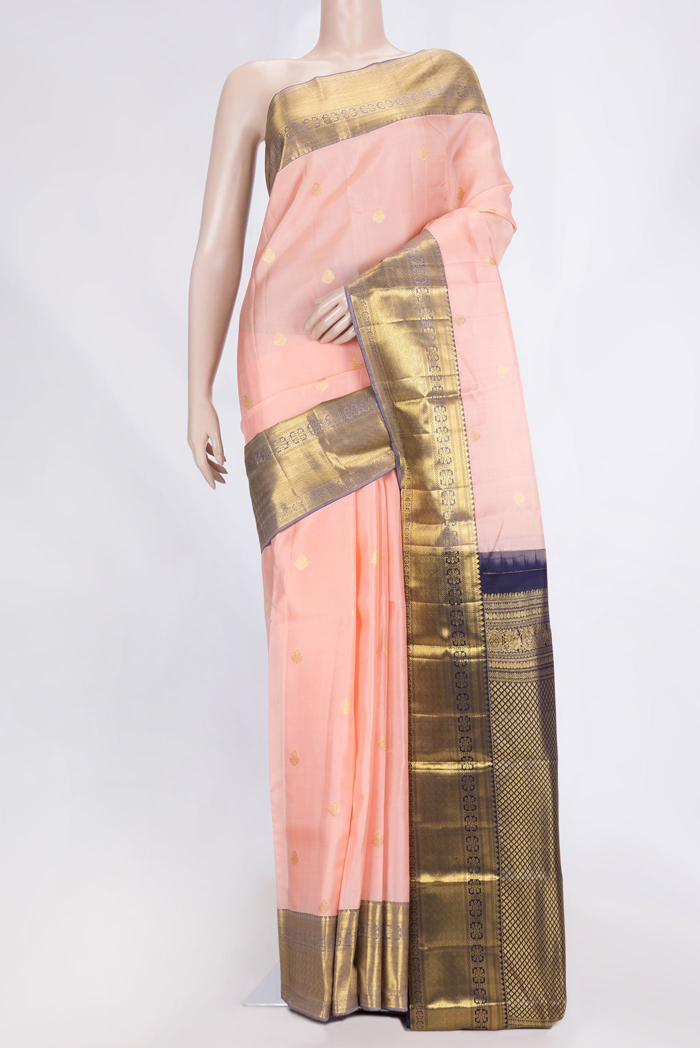Golden Peach Dual Tone Kanjivaram Saree with Zari Butta on the body and Zari Border.  displayed on a mannequin