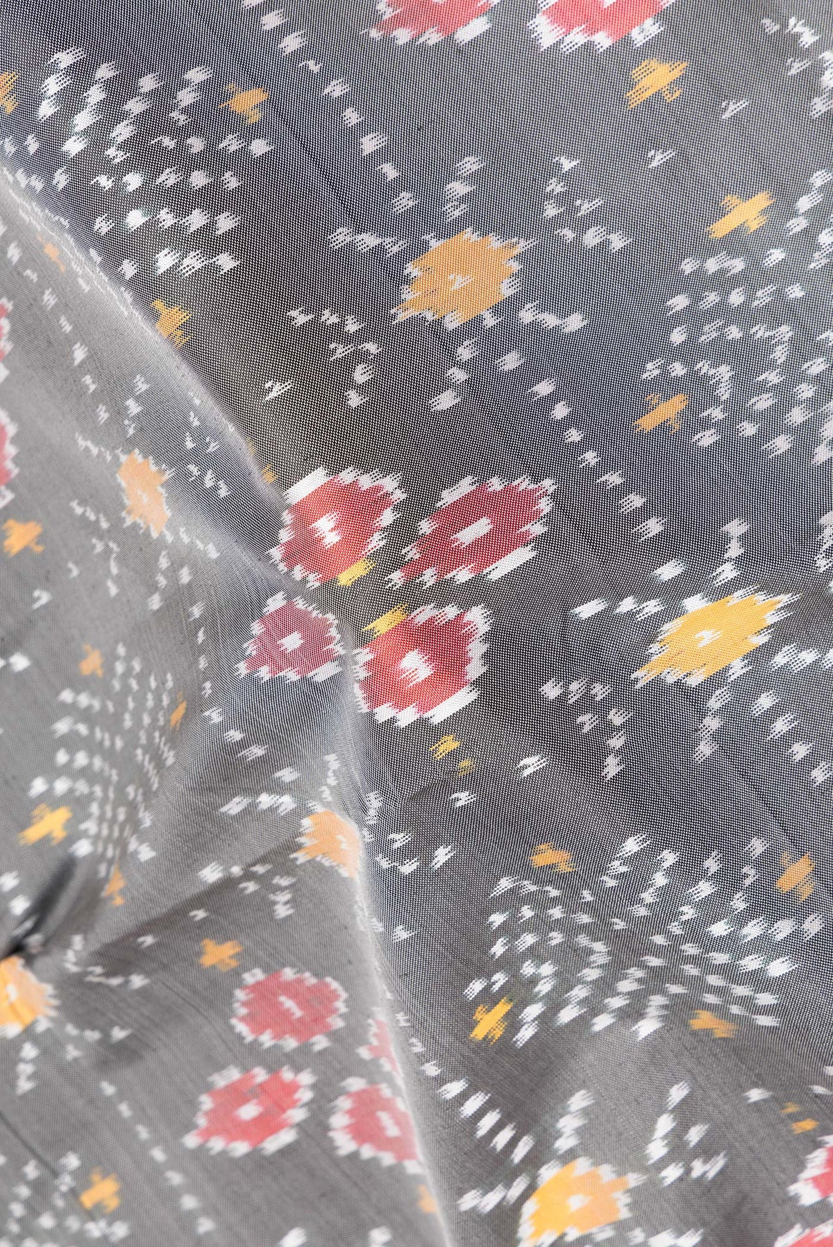 Close up of Pure Silk Grey Pochampally Saree with Ikat design on the body and Zari Border.  displaying folds