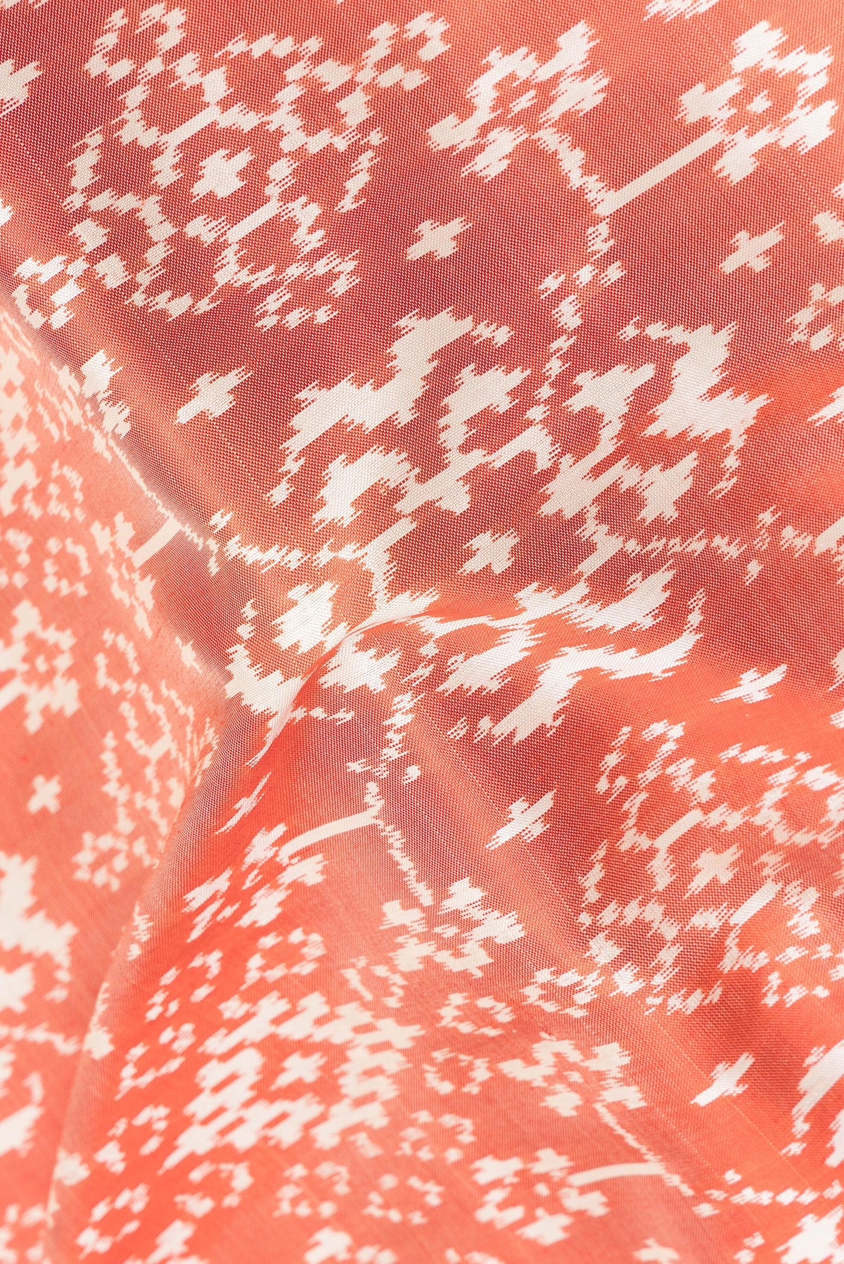 Close up of Pure Silk Rust Pochampally Saree with Ikat design on the body and Ikat Border.  displaying folds