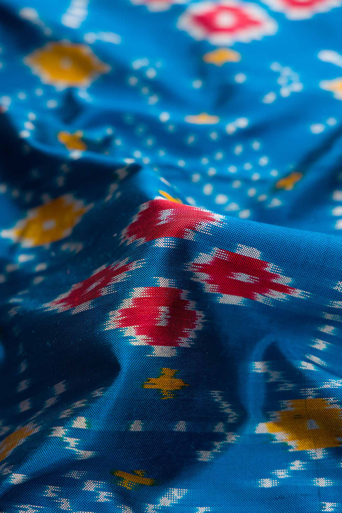 Close up of Blue Pochampally Silk Saree with Pure Ikat on the body and Zari Border displaying folds