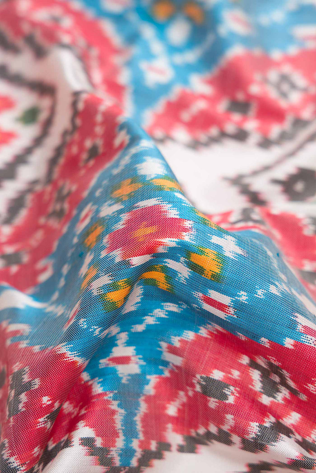 Close up of Off White Pochampally Silk Saree with Pure Ikat on the body and Zari Border displaying folds