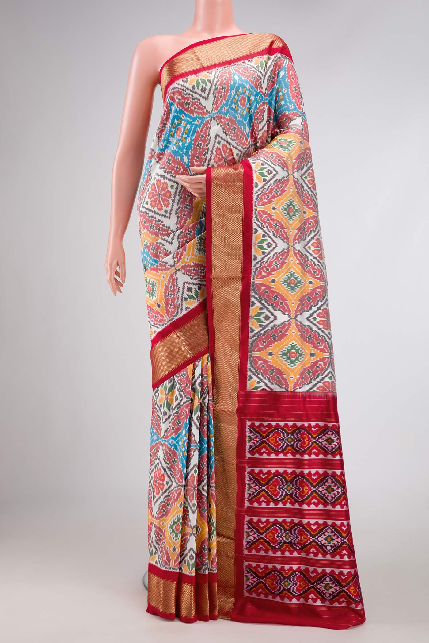 Off White Pochampally Silk Saree with Pure Ikat on the body and Zari Border displayed on a mannequin