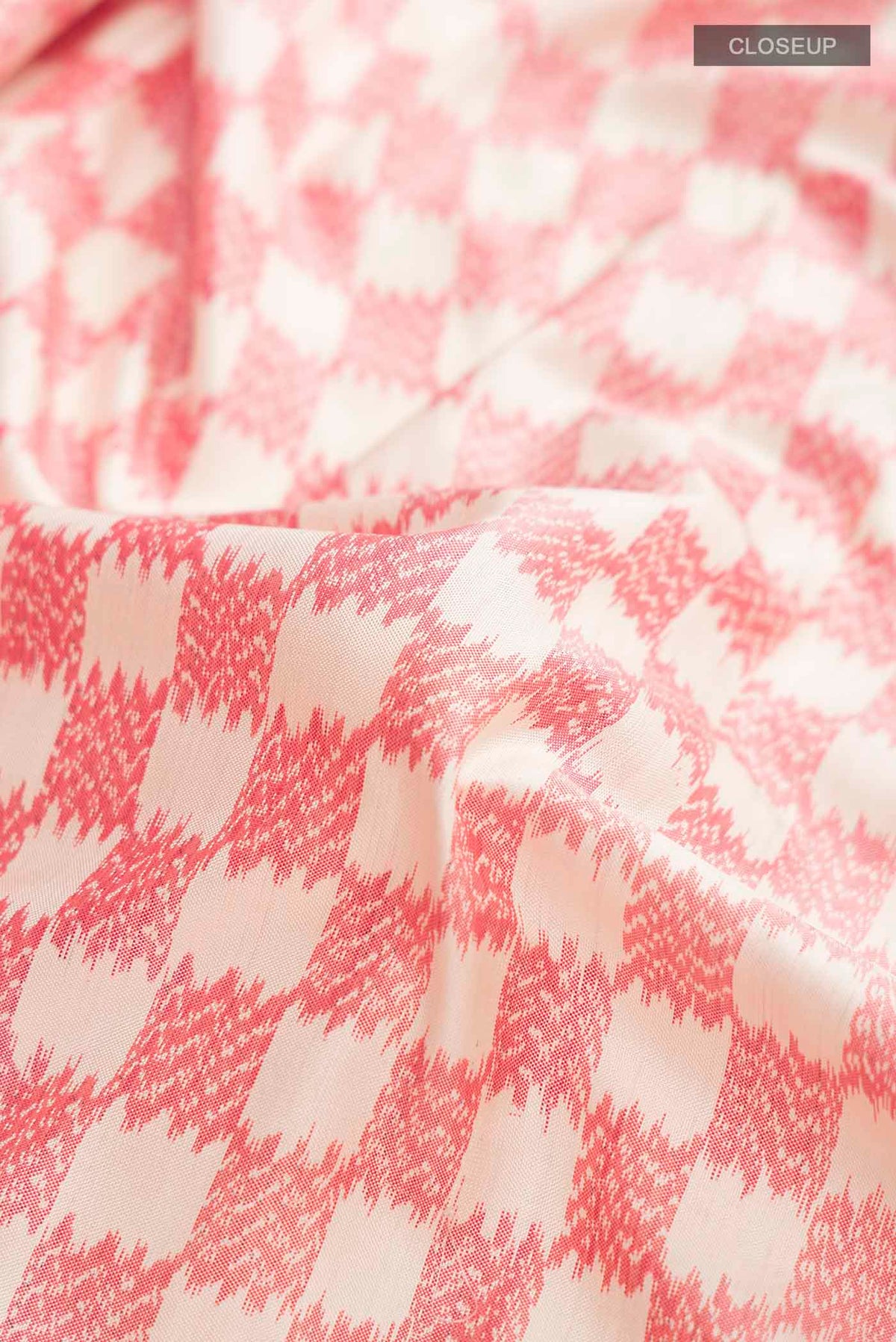 Close up of Cream Pochampally Silk Saree with Pure Ikat on the body and Plain Border displaying folds