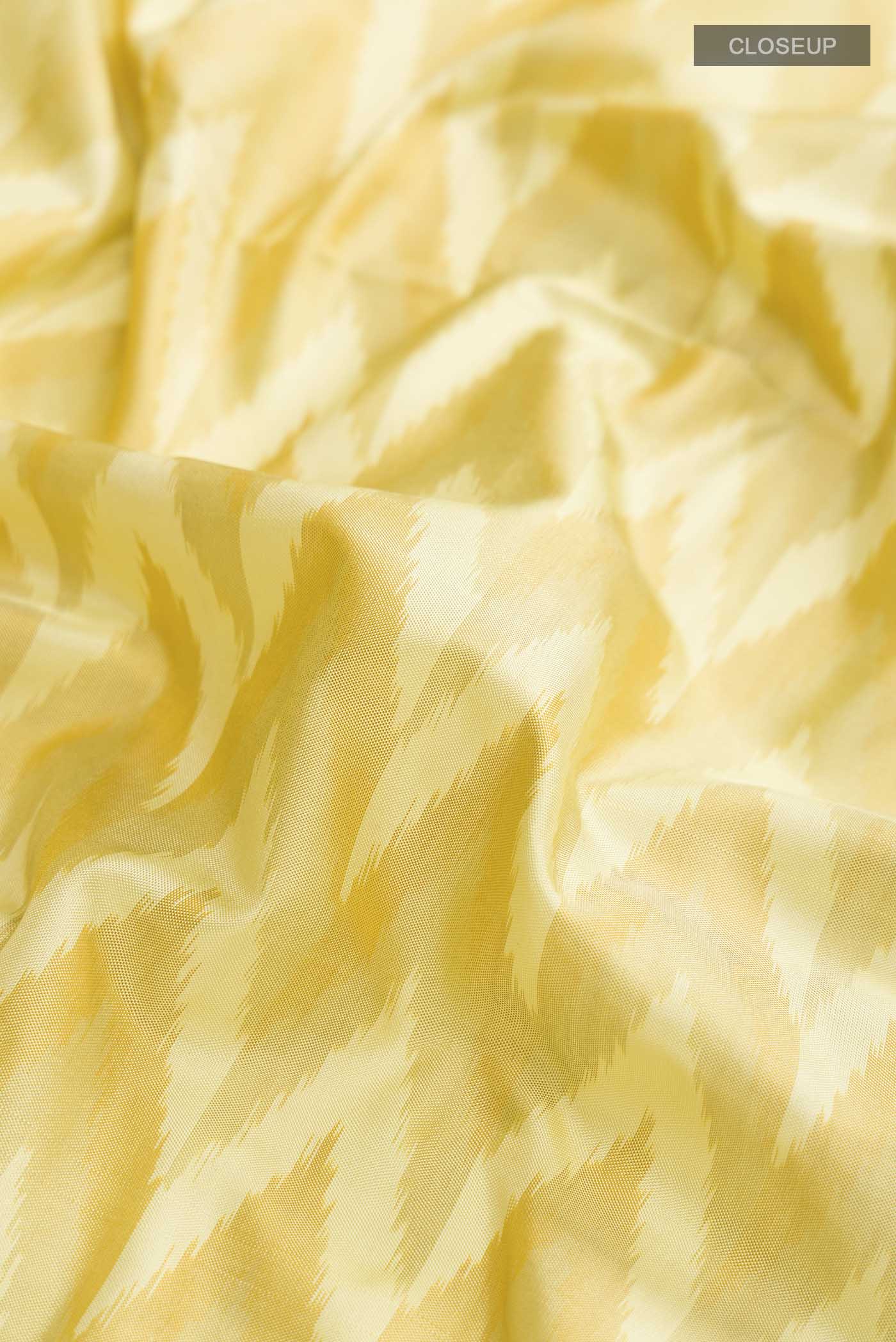 Close up of Yellow Pochampally Silk Saree with Pure Ikat on the body and Zari Border displaying folds