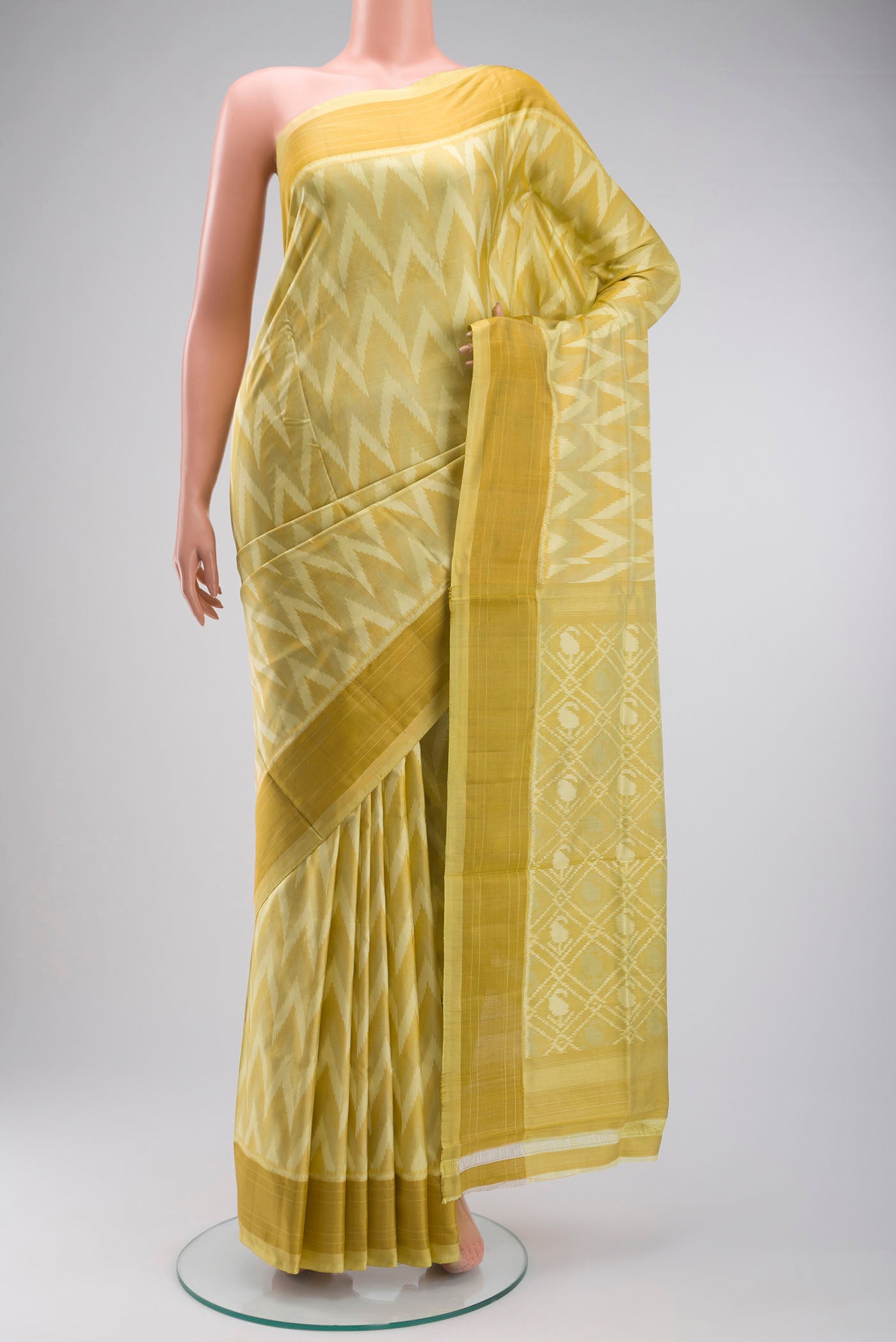 Yellow Pochampally Silk Saree with Pure Ikat on the body and Zari Border displayed on a mannequin