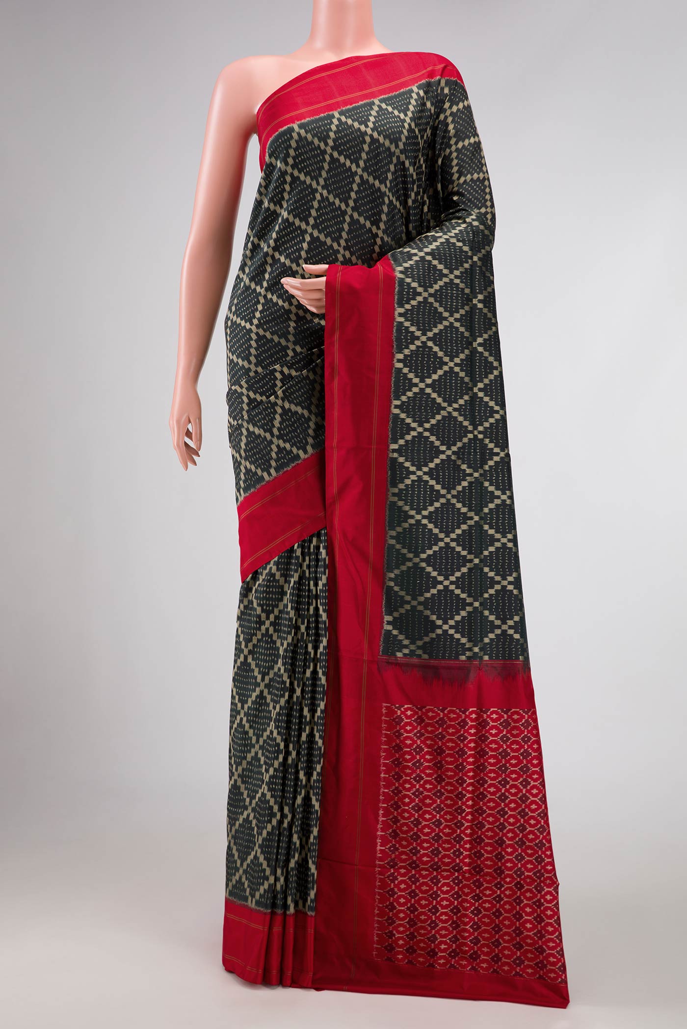 Black Pochampally Silk Saree with Pure Ikat on the body and Plain Border displayed on a mannequin