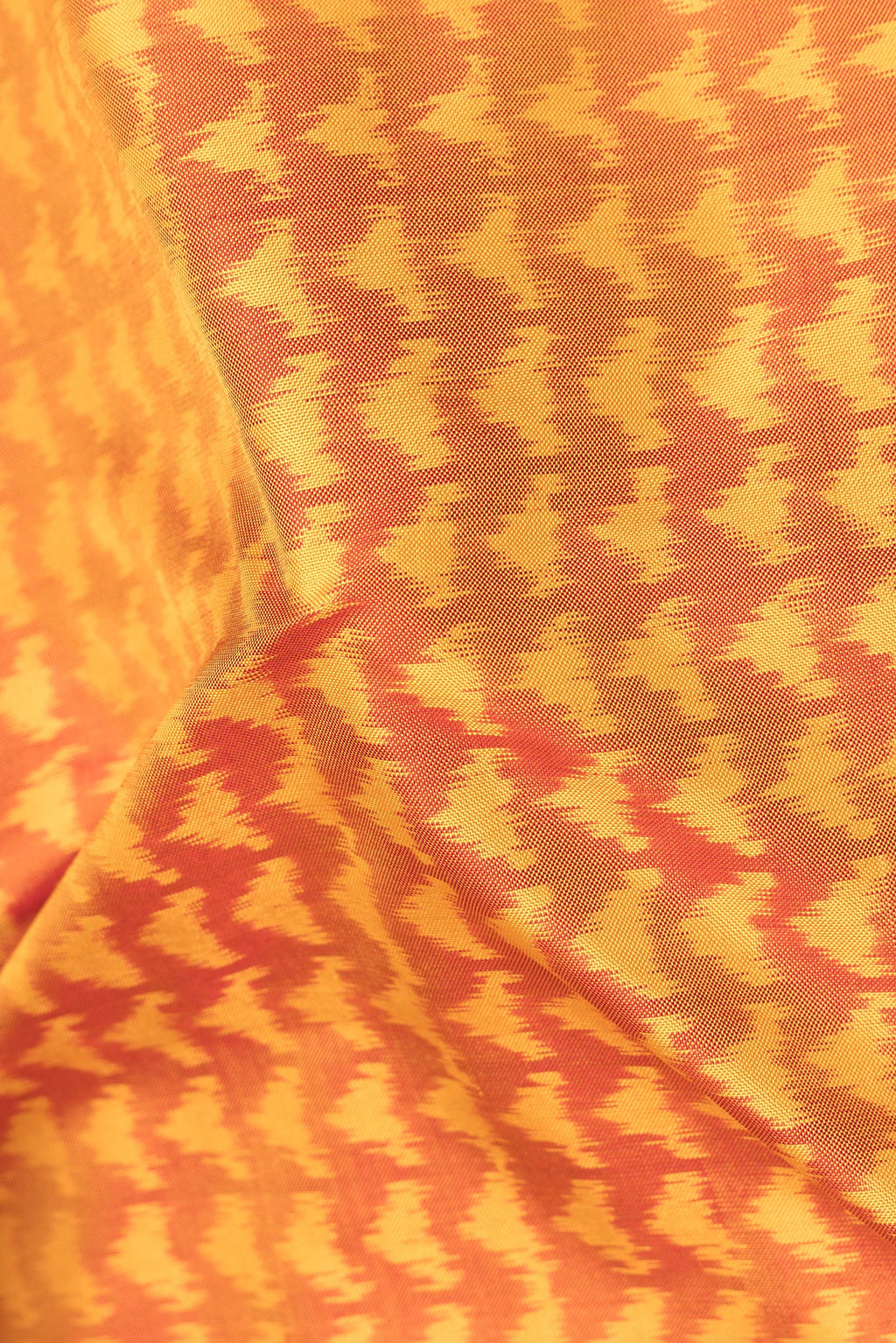Close up of Pure Silk Mustard Pochampally Saree with Pure Ikat on the body and Plain Border.  displaying folds