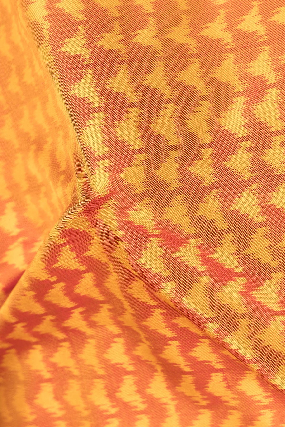 Close up of Pure Silk Mustard Pochampally Saree with Pure Ikat on the body and Plain Border.  displaying folds