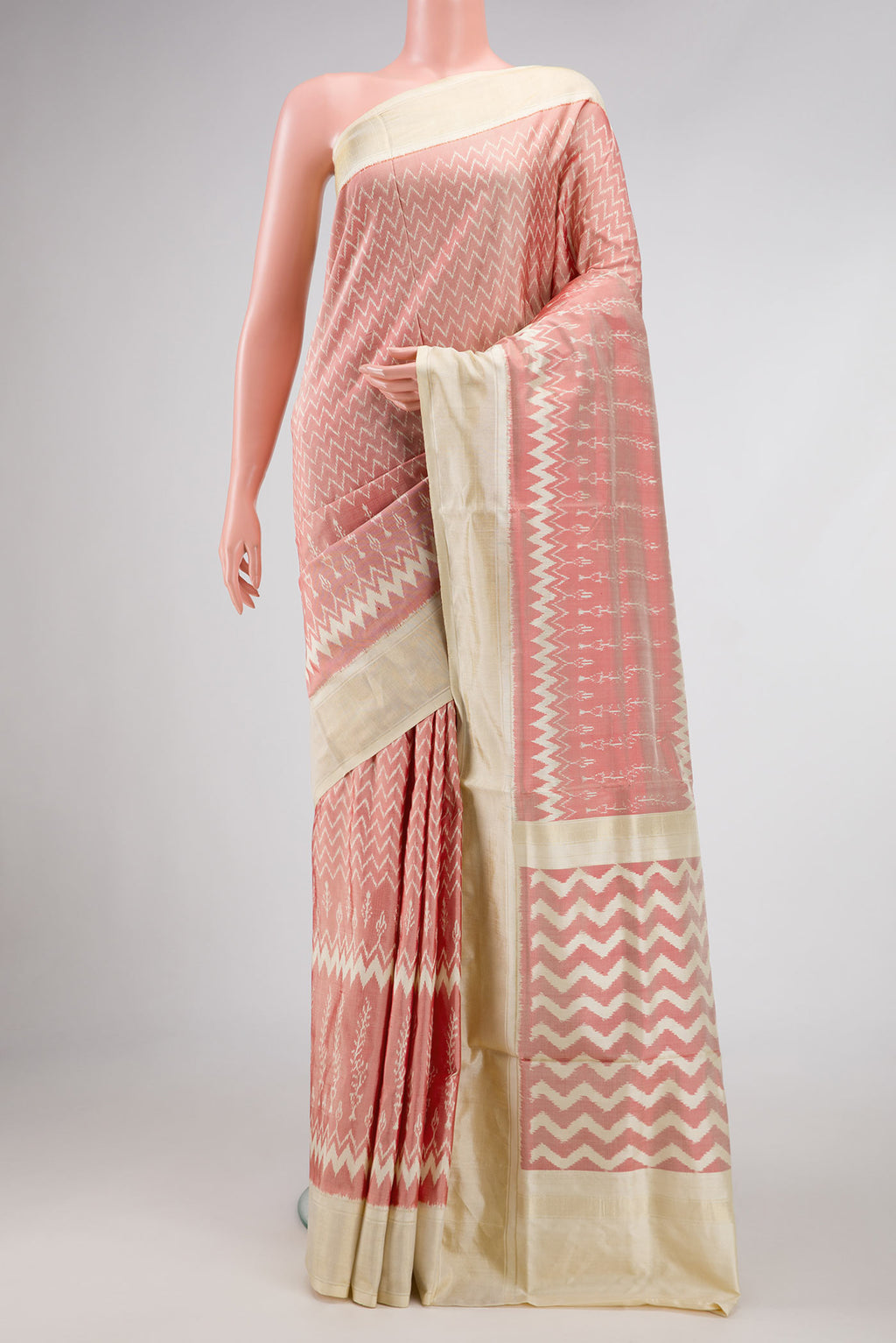 Coral Pochampally Silk Saree with Pure Ikat on the body and Zari Border displayed on a mannequin