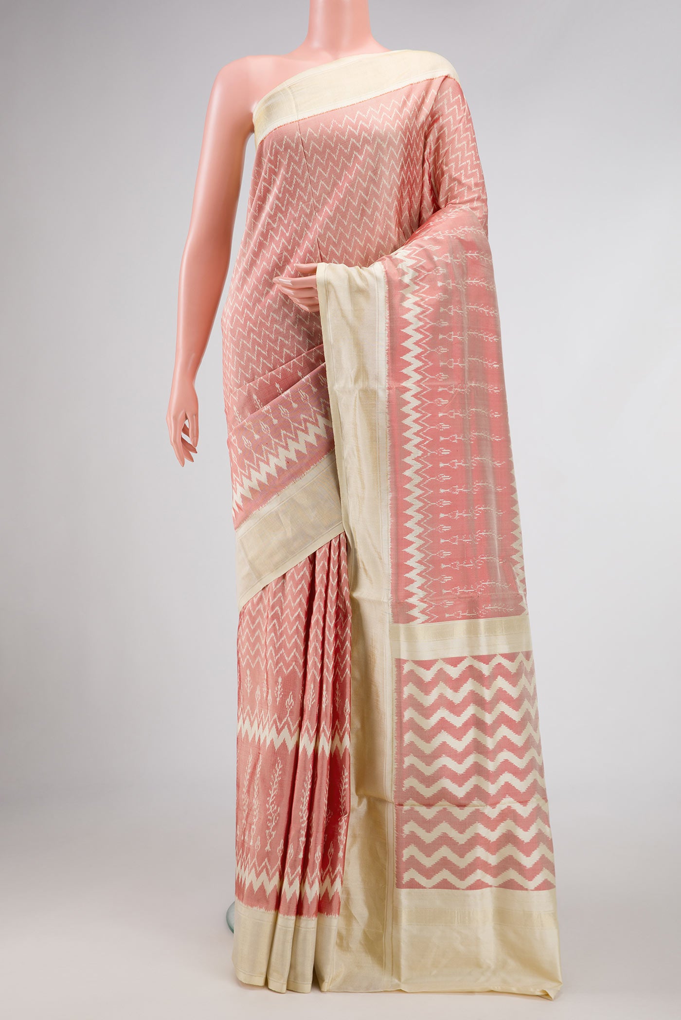 Coral Pochampally Silk Saree with Pure Ikat on the body and Zari Border displayed on a mannequin
