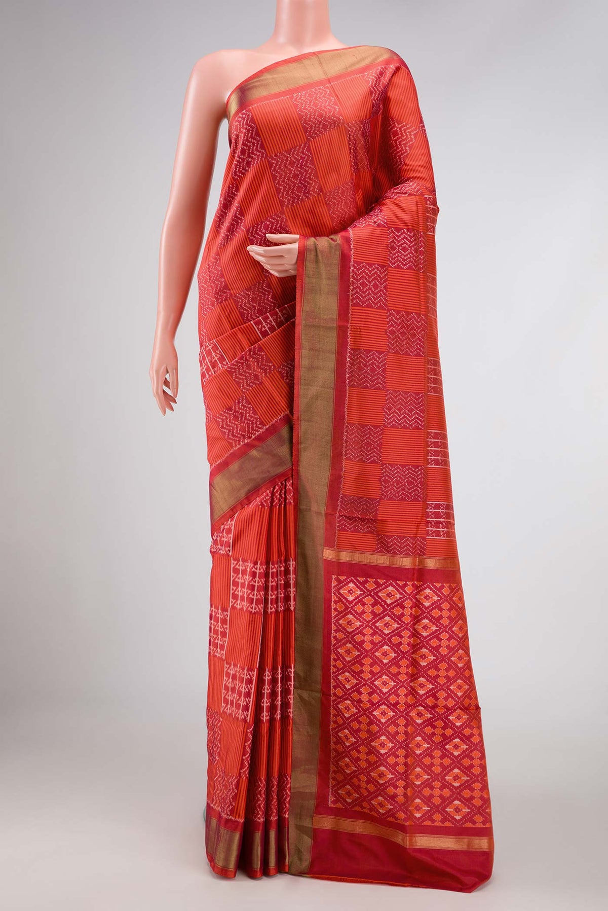 Orange Pochampally Silk Saree with Pure Ikat on the body and Zari Border displayed on a mannequin