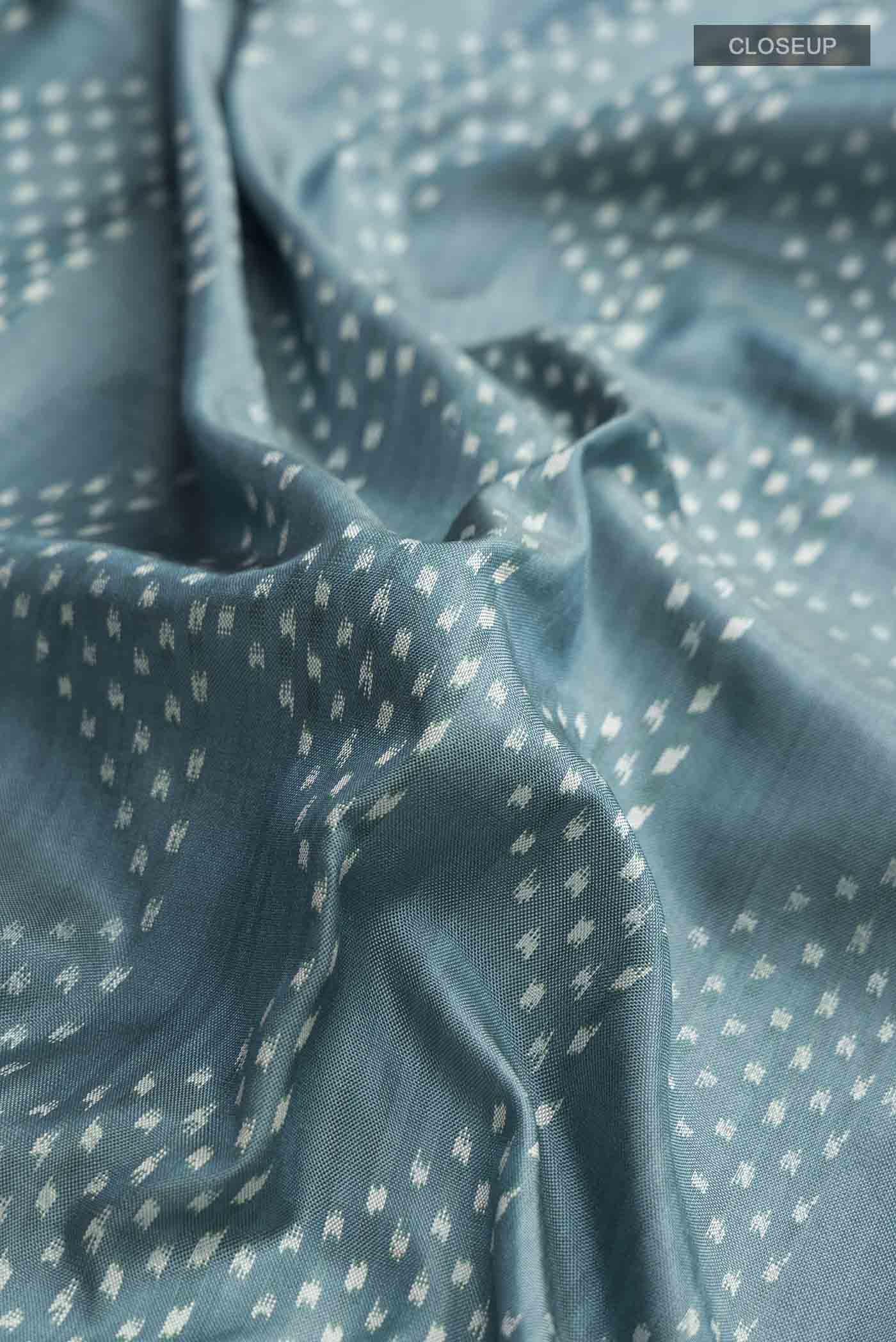 Close up of Grey Pochampally Silk Saree with Pure Ikat on the body and Plain Border displaying folds
