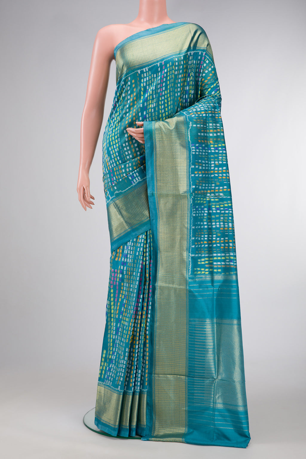 Peacock Blue Dual Tone Double Ikat Saree with Ikat Print on the body and Zari Border.  displayed on a mannequin
