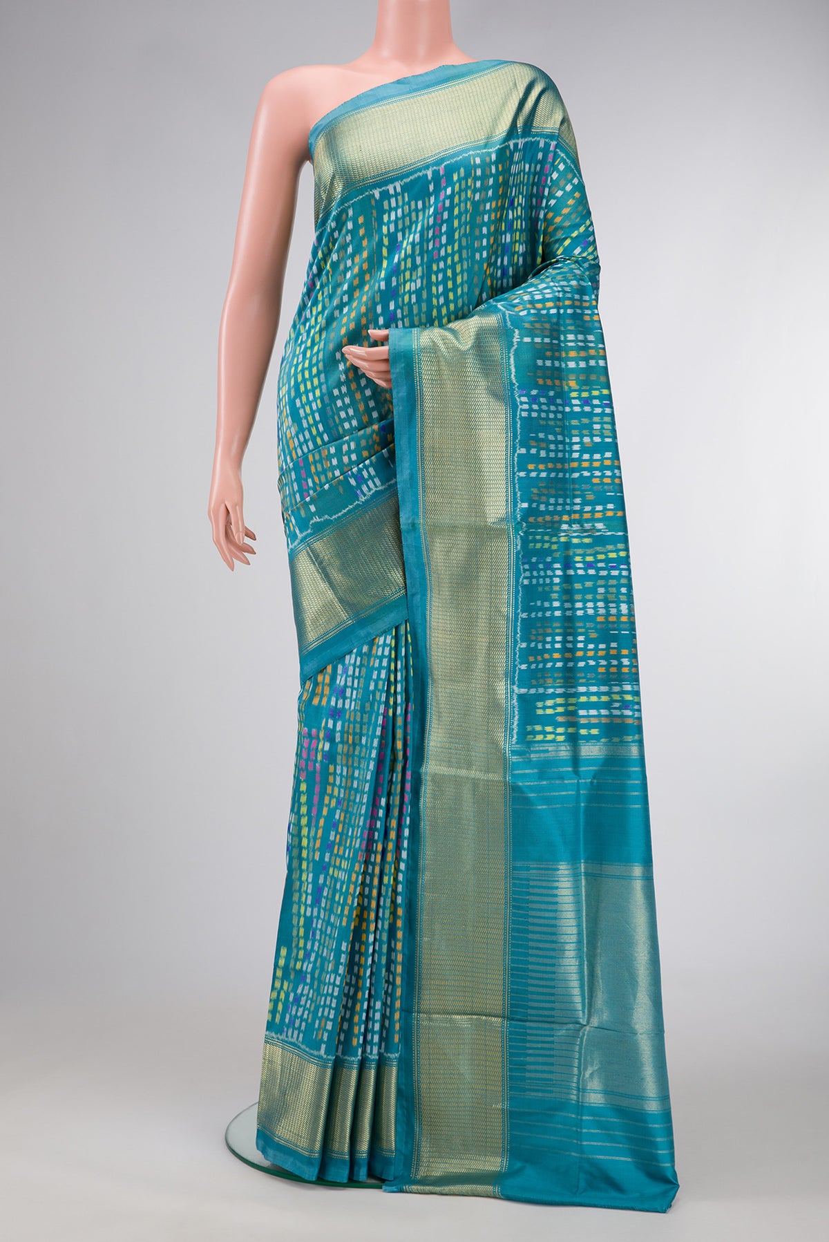 Peacock Blue Dual Tone Double Ikat Saree with Ikat Print on the body and Zari Border.  displayed on a mannequin