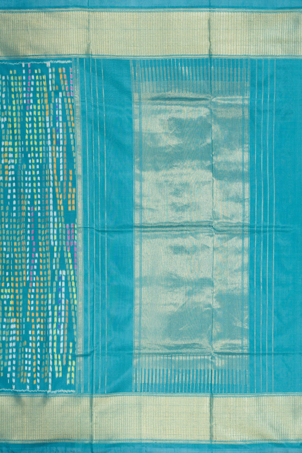Close up image of the pallu of Peacock Blue Dual Tone Double Ikat Saree with Ikat Print on the body and Zari Border. 