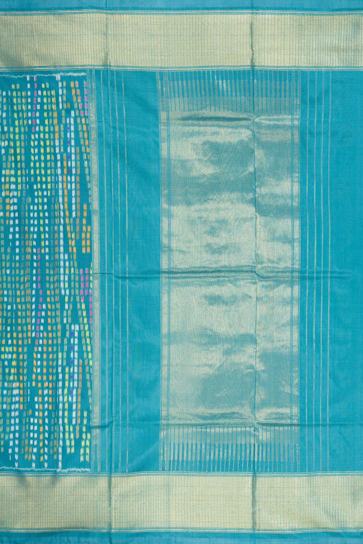 Close up image of the pallu of Peacock Blue Dual Tone Double Ikat Saree with Ikat Print on the body and Zari Border. 