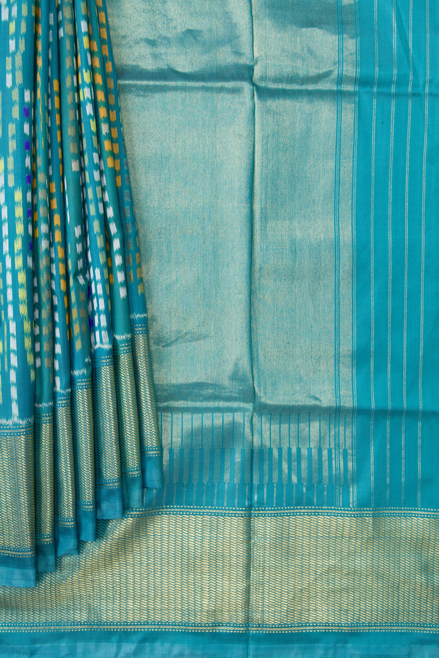 Pleats and pallu of Peacock Blue Dual Tone Double Ikat Saree with Ikat Print on the body and Zari Border. 