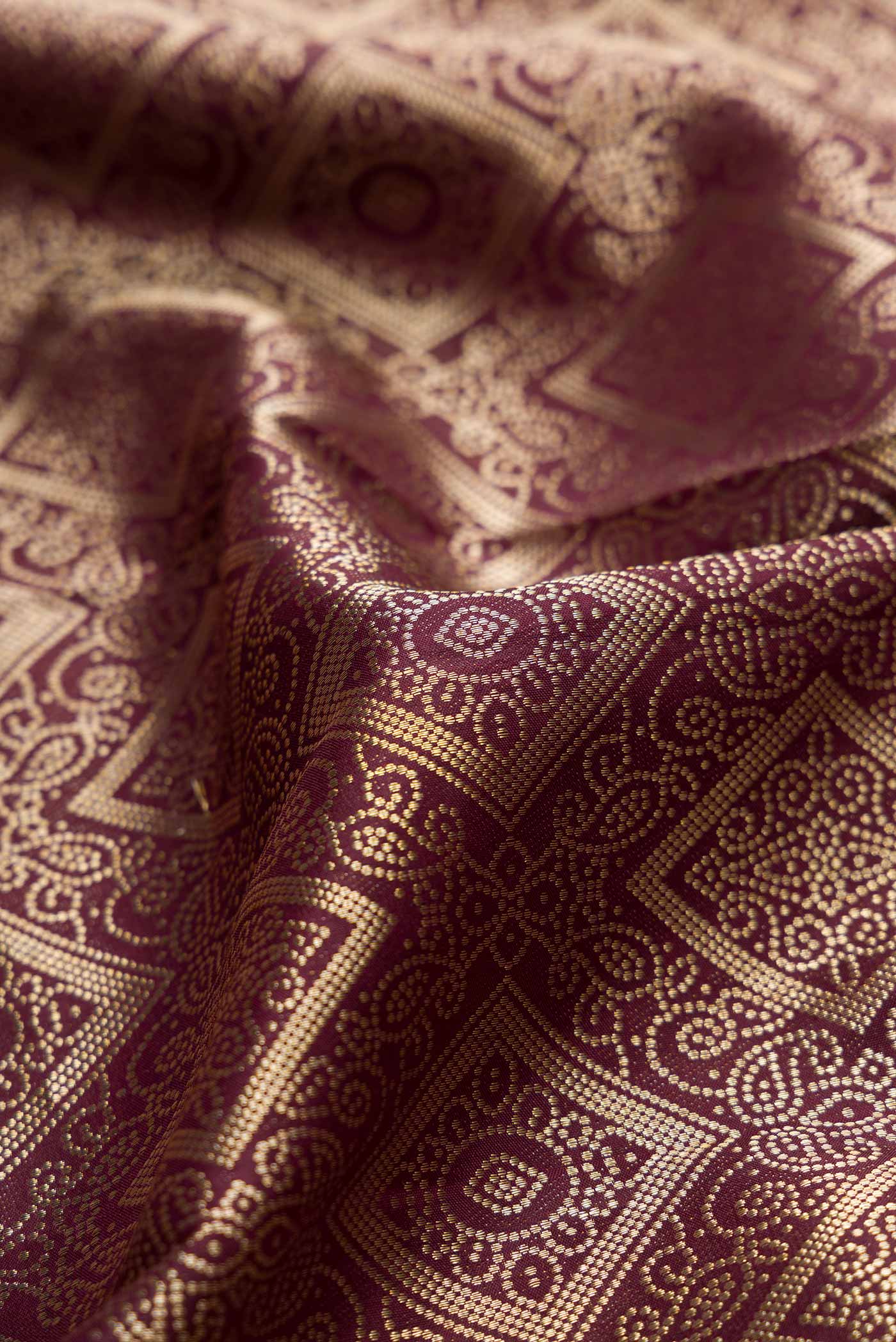 Close up of Coffee Brown Dual Tone Kanchipuram Silk Saree with Zari Brocade on the body and Zari Border.  displaying folds