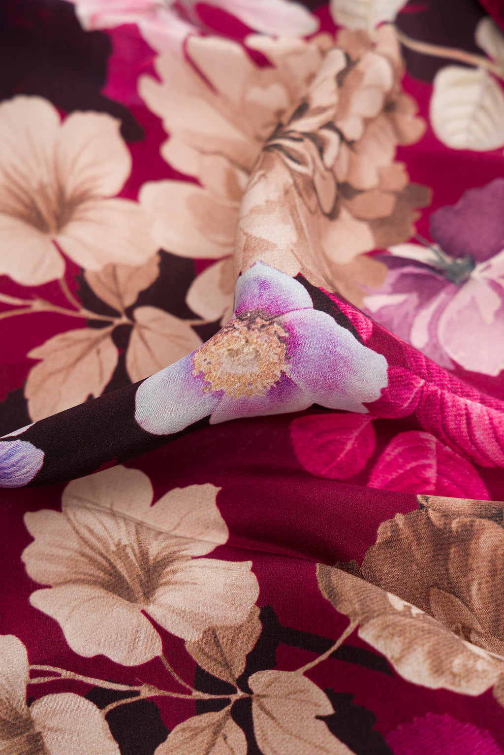 Close up of Burgundy Dual Tone Mysore Crepe Saree with Printed design on the body and Plain Border.  displaying folds