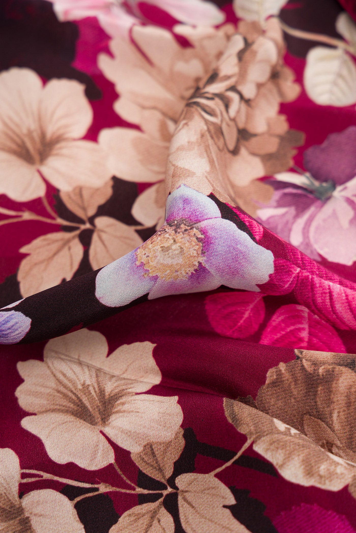 Close up of Burgundy Dual Tone Mysore Crepe Saree with Printed design on the body and Plain Border.  displaying folds