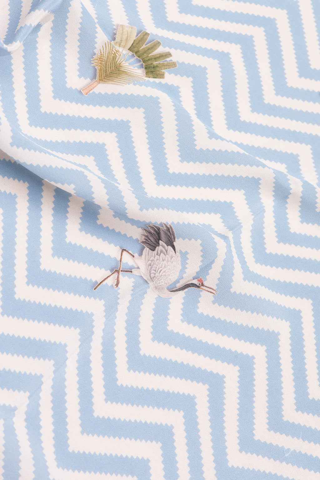 Close up of Light Blue Dual Tone Mysore Crepe Saree with Printed design on the body and Without Border.  displaying folds