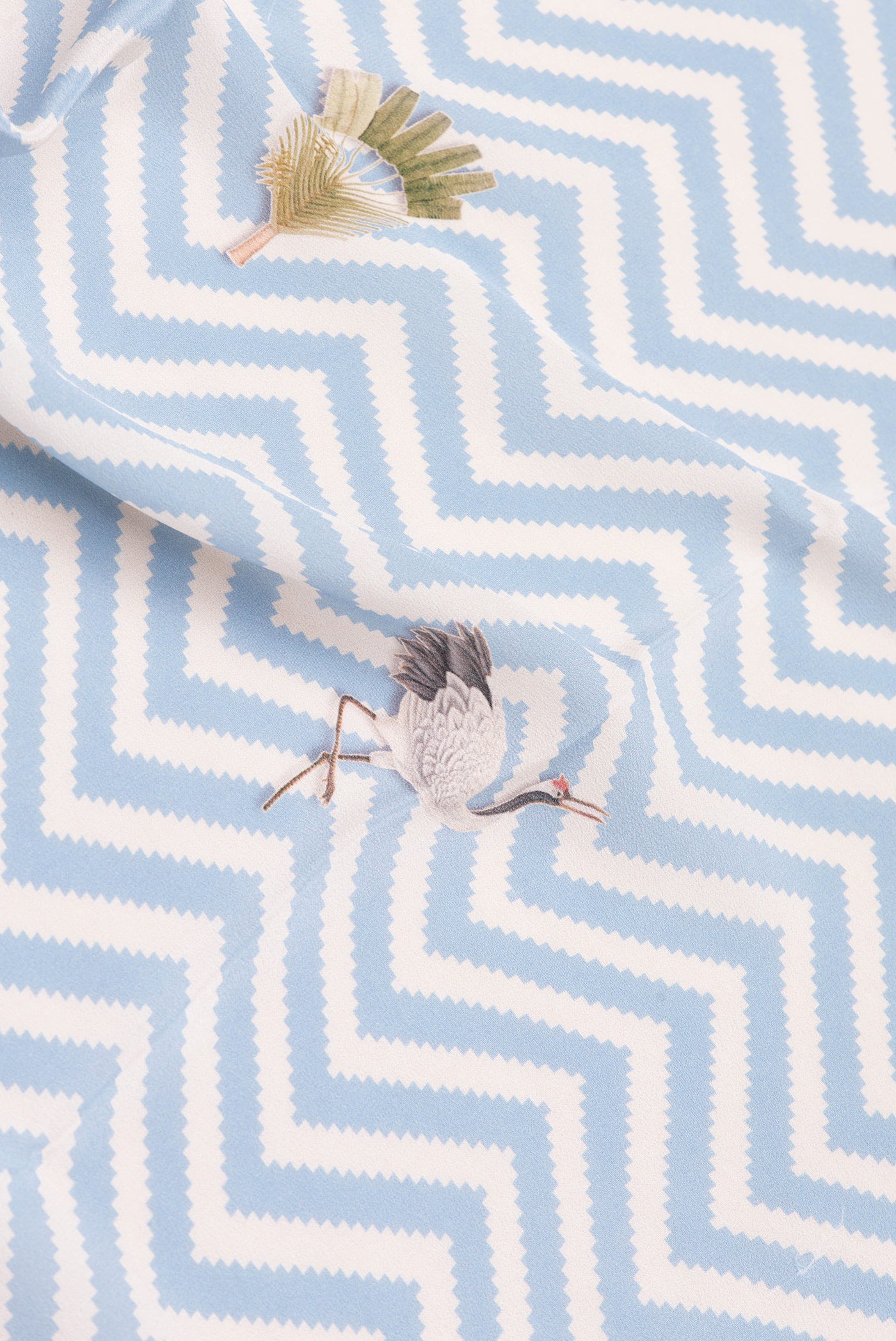 Close up of Light Blue Dual Tone Mysore Crepe Saree with Printed design on the body and Without Border.  displaying folds