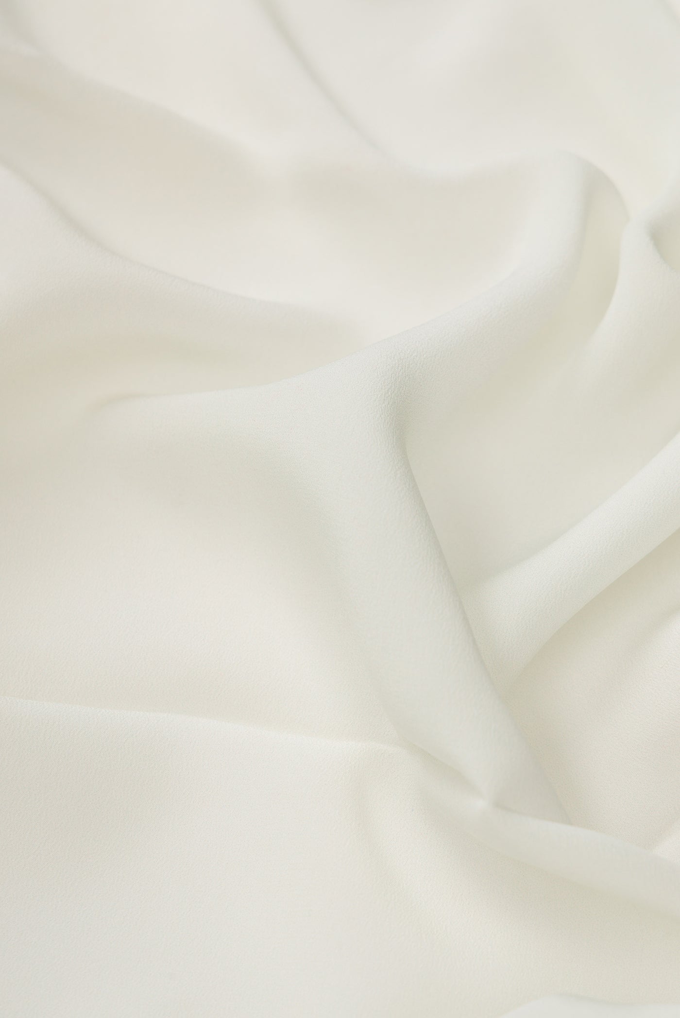 Close up of Off White Dual Tone Mysore Crepe Saree with Plain Body and Printed Border.  displaying folds